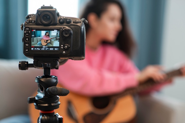 Blogger recording video with guitar lesson