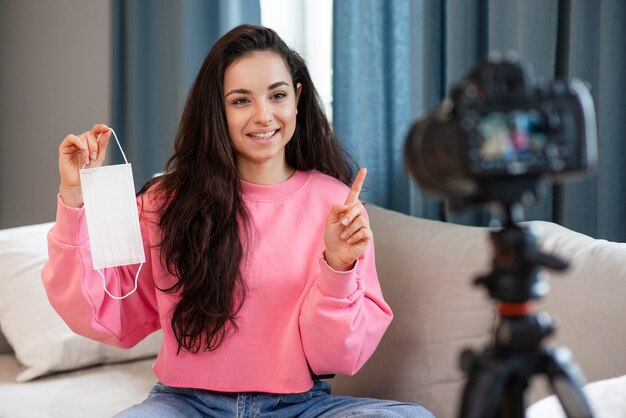 Blogger showing surgical mask at camera