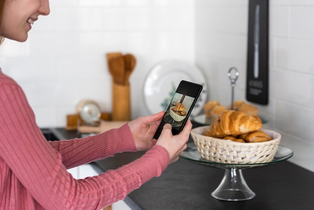 Blogger taking a photo of croissants