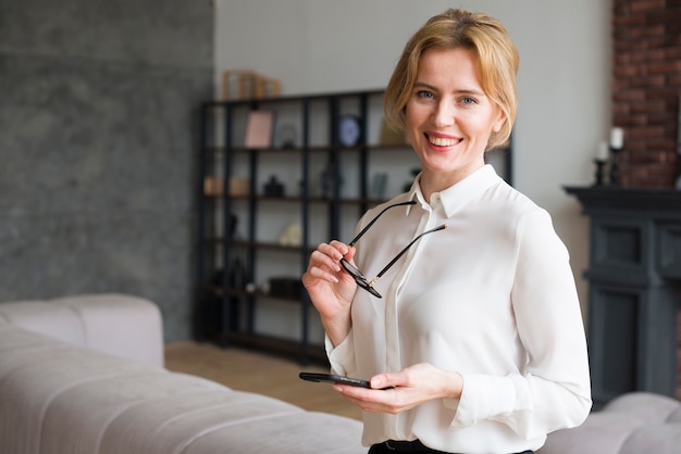 Blond business woman using smartphone 