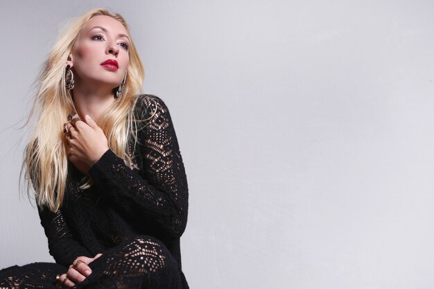 Blond fashion model in black lace dress