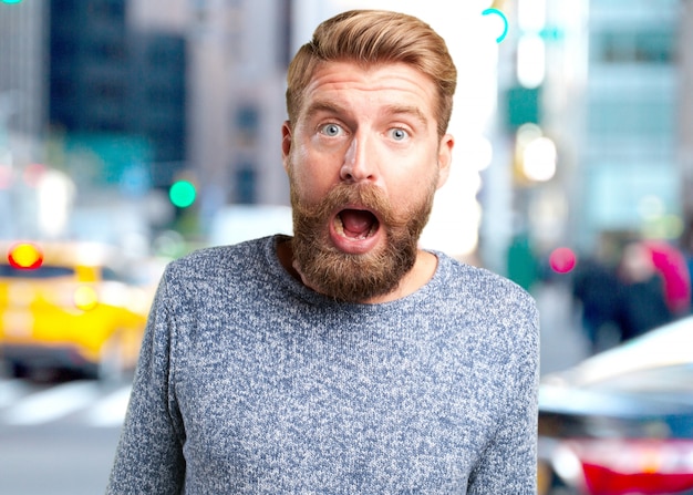 Free photo blond hipster. surprised expression