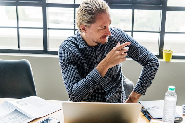 Blond man busy at work