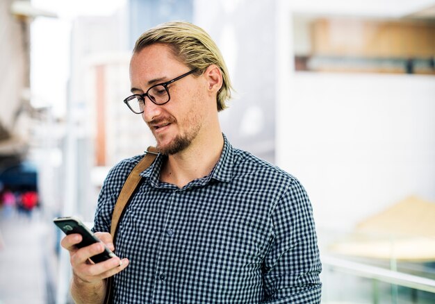 Blond man texting on his phone