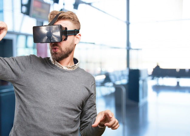 Free photo blond man with virtual glasses. surprised expression