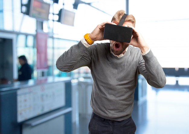 Free photo blond man with virtual glasses. surprised expression