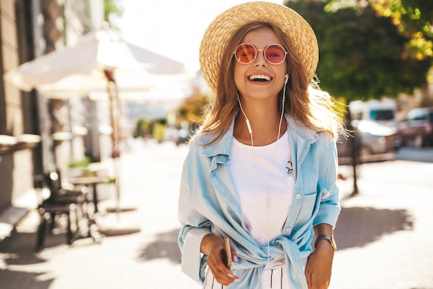 blond model in summer clothes posing on the street