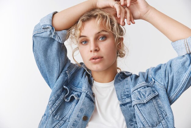 blond woman   model pose with hands raised relaxed on her head