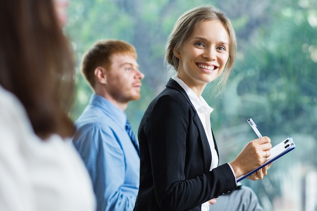 Blond woman smiling with a tablet