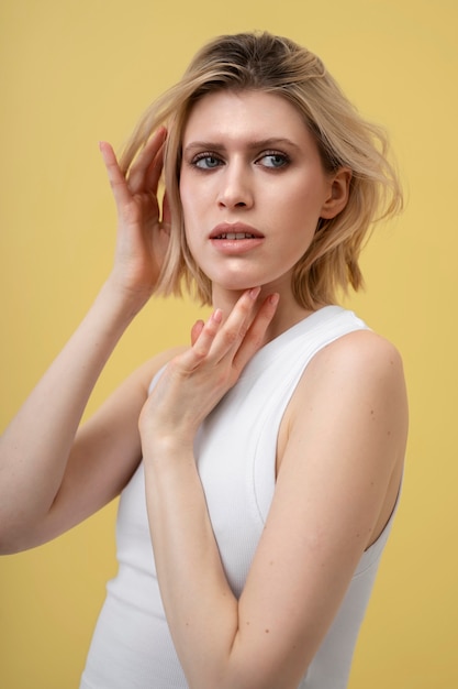 Blond woman with shiny skin posing