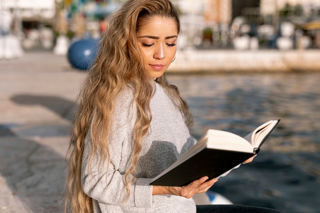 Blonde beautiful woman reading