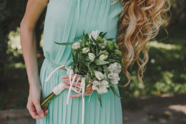 Blonde bridemaid with bouquet