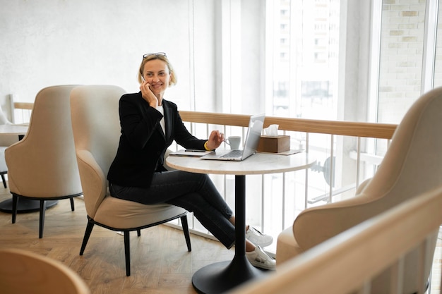 Blonde business woman working on her laptop