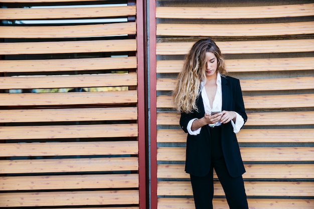 Blonde businesswoman with smartphone