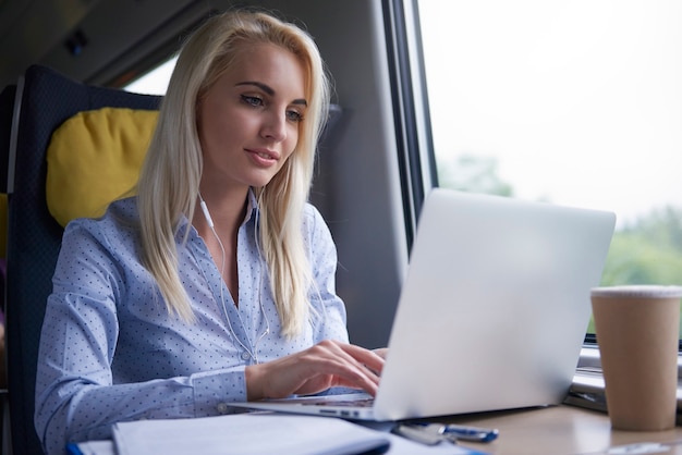 Blonde businesswoman working in the train