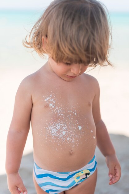 Blonde child at the beach medium shot