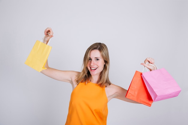 Blonde dancing woman with shopping bags
