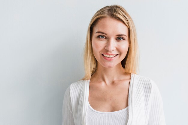 Blonde employee looking at camera on white background