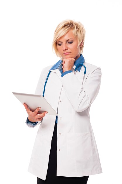 Blonde female doctor contemplating from patient's result