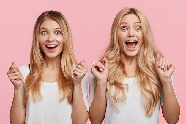 Blonde female friends dressed in white