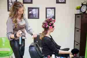 Free photo blonde girl getting her hair done