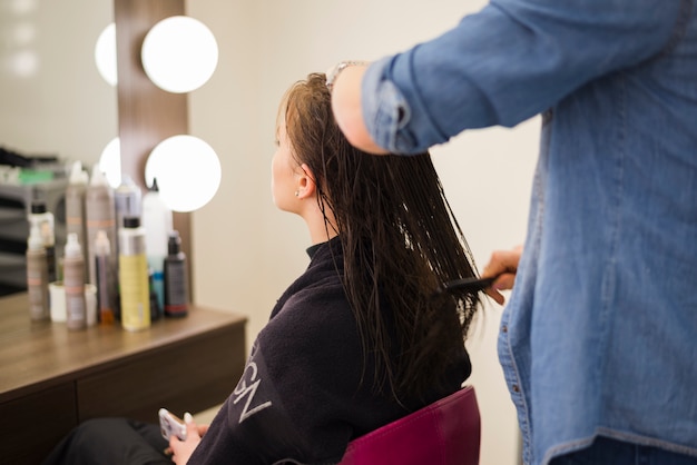 Free photo blonde girl getting her hair done