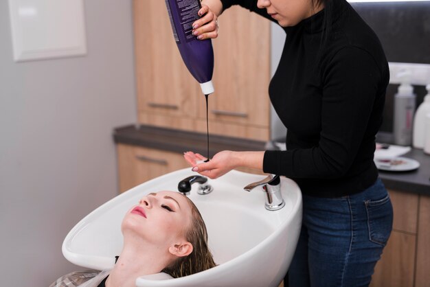 Blonde girl getting her hair dyeing