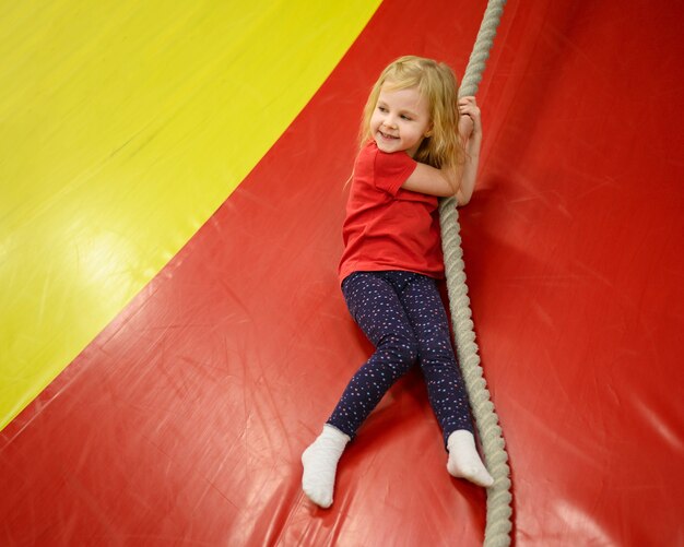 blonde girl holding a rope