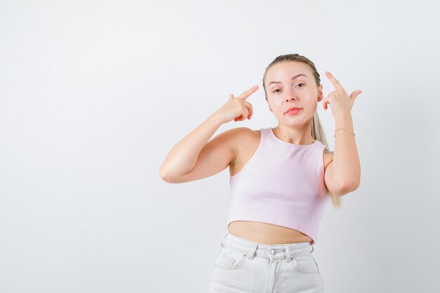 Blonde girl is doing rap on white background