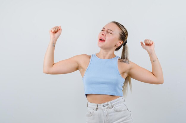 blonde girl is growling on white background