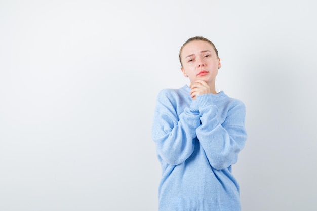 Blonde girl is pleading something on white background