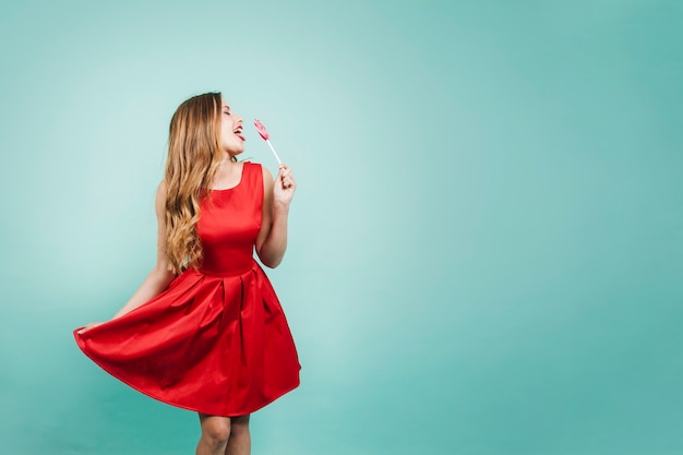 Blonde girl licking lollipop