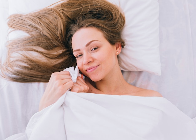 Free photo blonde girl posing on the bed