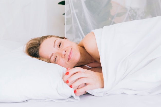 Blonde girl posing on the bed