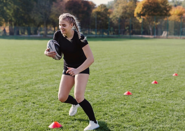 Free photo blonde girl running through cones