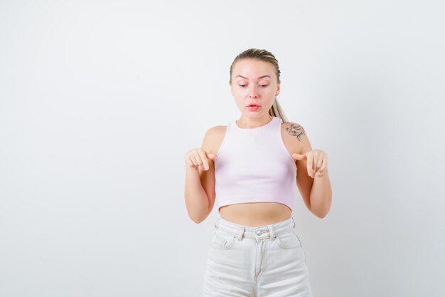 Blonde girl sees something on white background