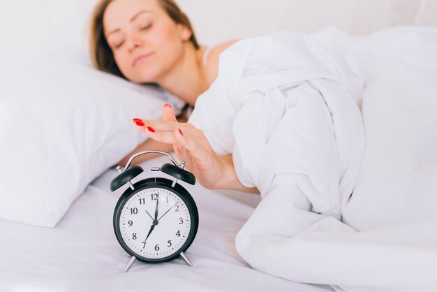 Blonde girl setting off the clock alarm