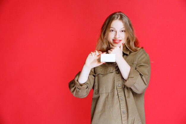 Blonde girl showing her business card and networking.