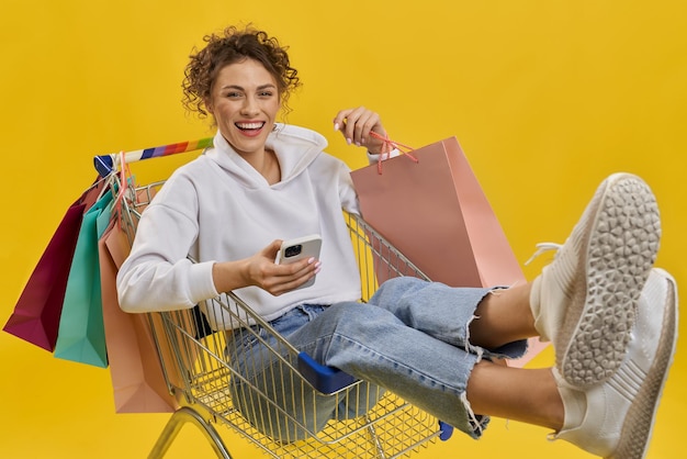 Blonde girl sitting in cart smiling