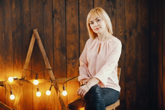 blonde girl sitting on a chair