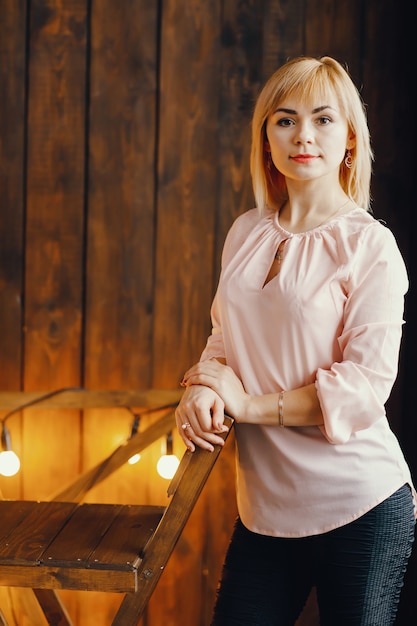 Free photo blonde girl sitting on a chair