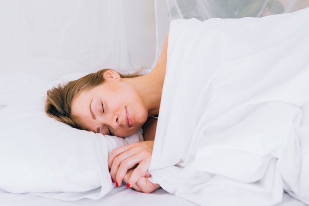 Blonde girl sleeping on the bed