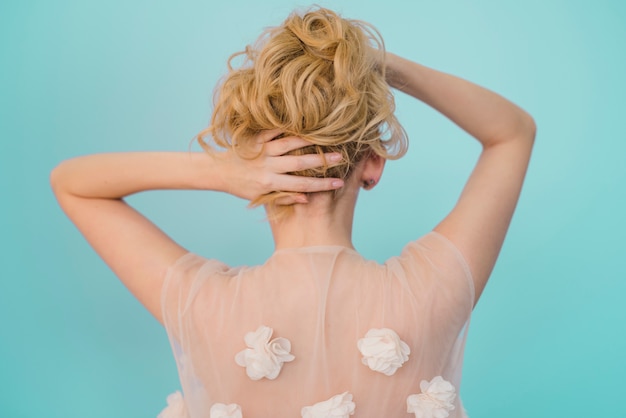 Blonde girl taking care of her hair