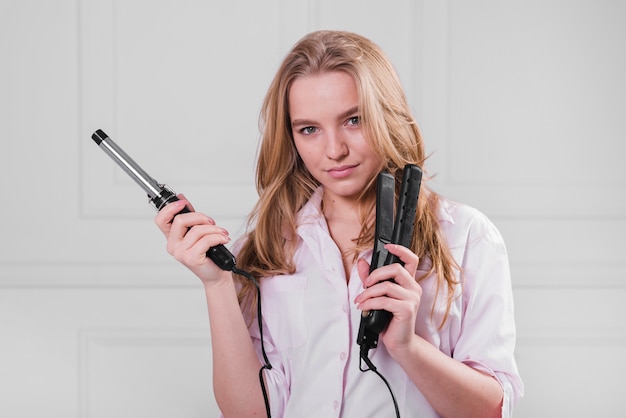 Free photo blonde girl taking care of her hair