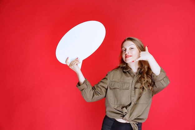 Ragazza bionda con una bacheca ovale che chiede un contatto.