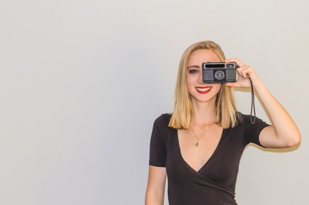 Blonde girl with vintage camera