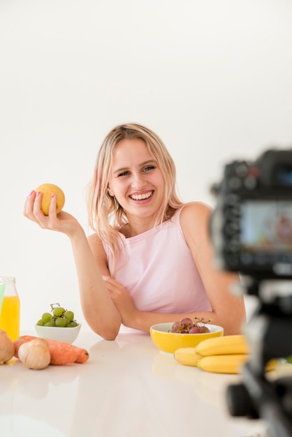 Free photo blonde influencer recording nutrition food