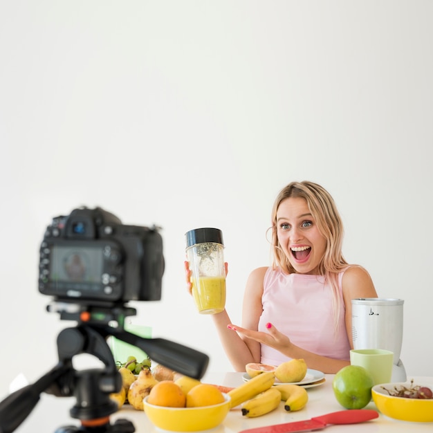 Free photo blonde influencer recording nutrition food