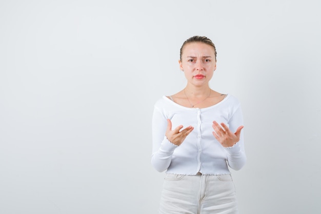 Blonde lady is showing hand figure on white background