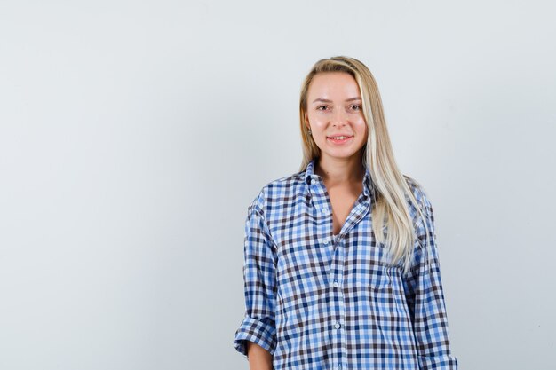 Blonde lady looking at camera in casual shirt and looking cheerful
